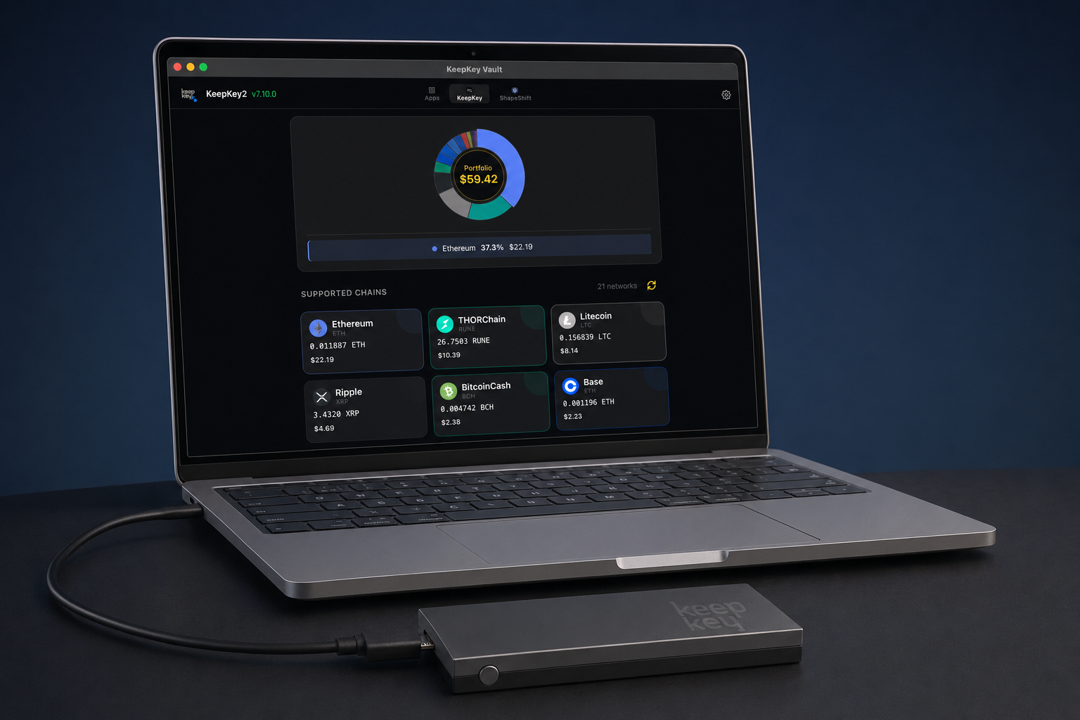 Vault Desktop on a laptop showing portfolio dashboard with KeepKey connected